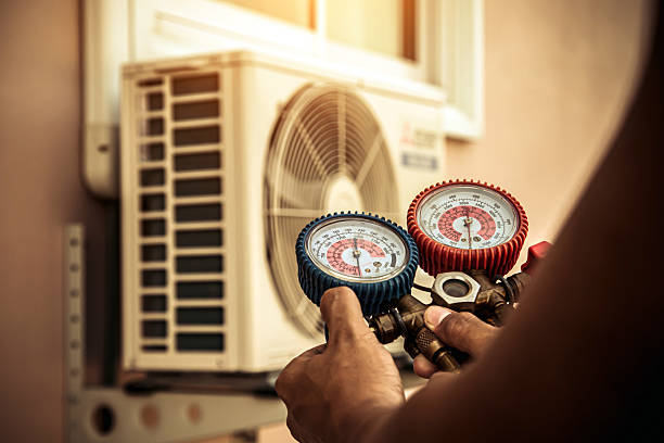 Professional Air Conditioning Service technician working in Spring Brook, NY